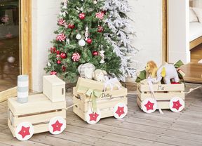 Personalised wooden gift train displayed beside a decorated Christmas tree.