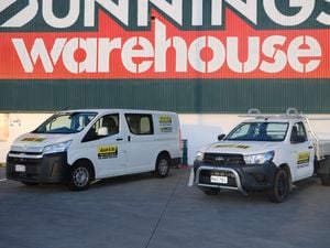 A van and a ute parked outside a Bunnings store
