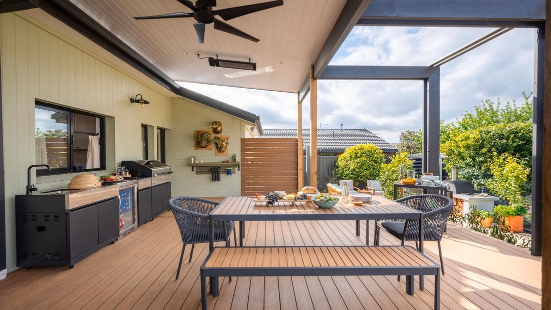 Outdoor entertaining area with an outdoor table, chairs, BBQ and a ceiling fan
