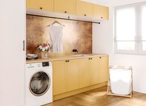 close up image with timber flooring, washing machine, overhead cupboards and washing hamper and white timber window