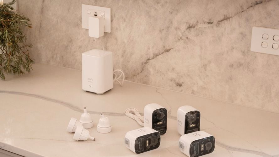 Four security cameras on top of a countertop.