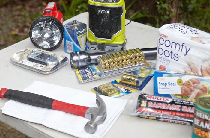 Batteries, a hammer, a towel, garbage bags, tool charge packs and a flashlight
