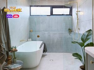 Green, gold and white coloured bathroom with a timber fluted profile vanity and marble benchtop and bath in it.