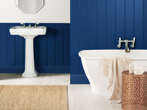 Modern bathroom with deep blue painted panelled walls