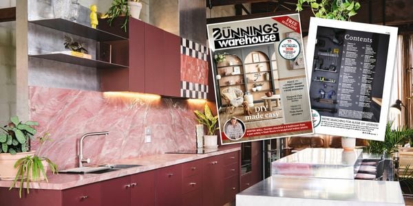 Modern kitchen with pink marble splashback and dark cabinetry, overlaid with images of the Bunnings Warehouse July 2026 magazine cover and a contents page.