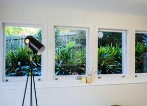 Lamp in a room with windows in it