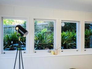 Lamp in a room with windows in it