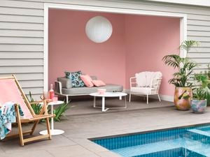 Outdoor area with pink feature wall.