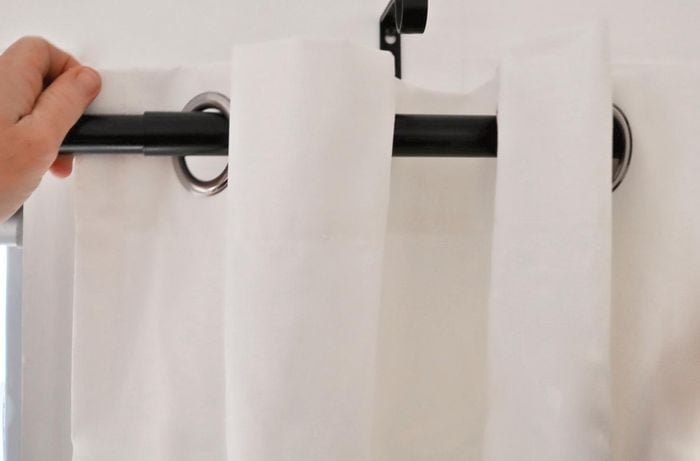 Threading a ready-made curtain through a curtain rod