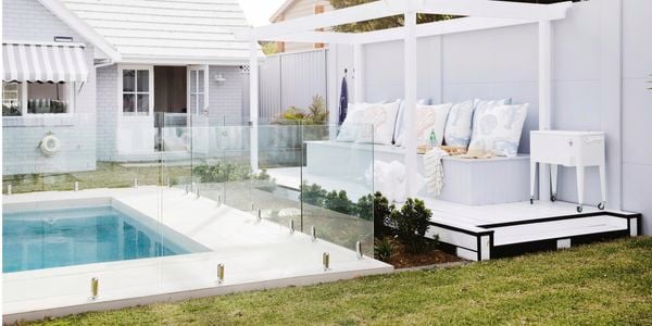 Outdoor area with pool and bench seat.