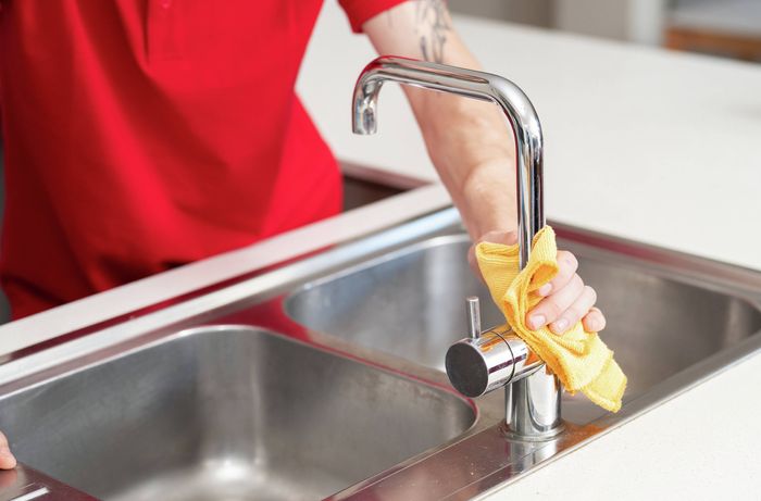 Clean kitchen tap and sink with a microfibre cloth​​