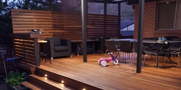 Outdoor tiered timber decking area with lights in-built.