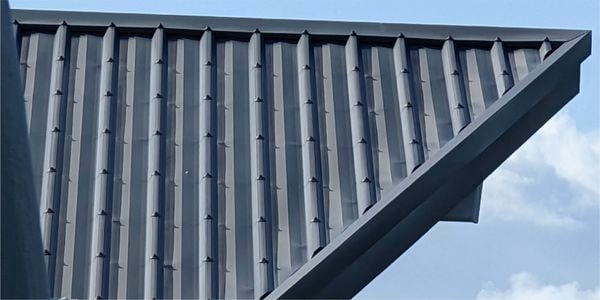Close-up of a grey metal roof with ridges