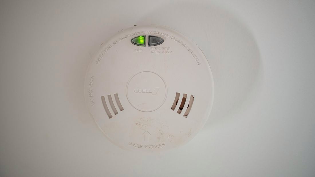 close up of a smoke alarm on a wall