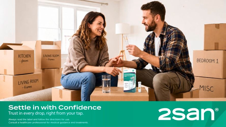 A couple unpacking boxes in their new, slightly unfurnished home.