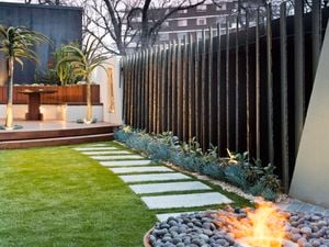 Backyard with stepping stones set in manicured turf