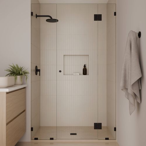 Framed alcove shower enclosure with clear glass, black hardware, and integrated wall niche.