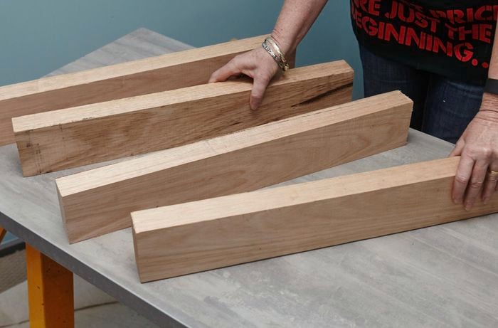 Four cut lengths of timber on a bench