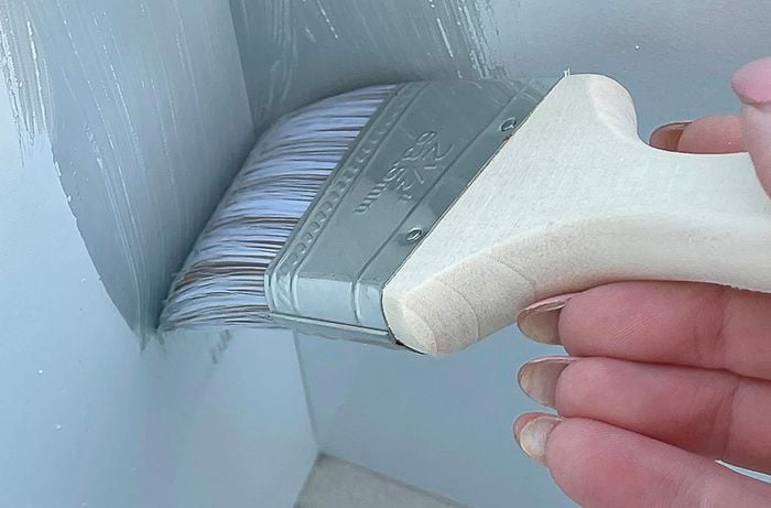 Persons hand painting cube unit