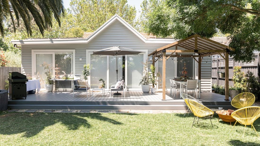 Backyard with a decking, outdoor furniture and gazebo.