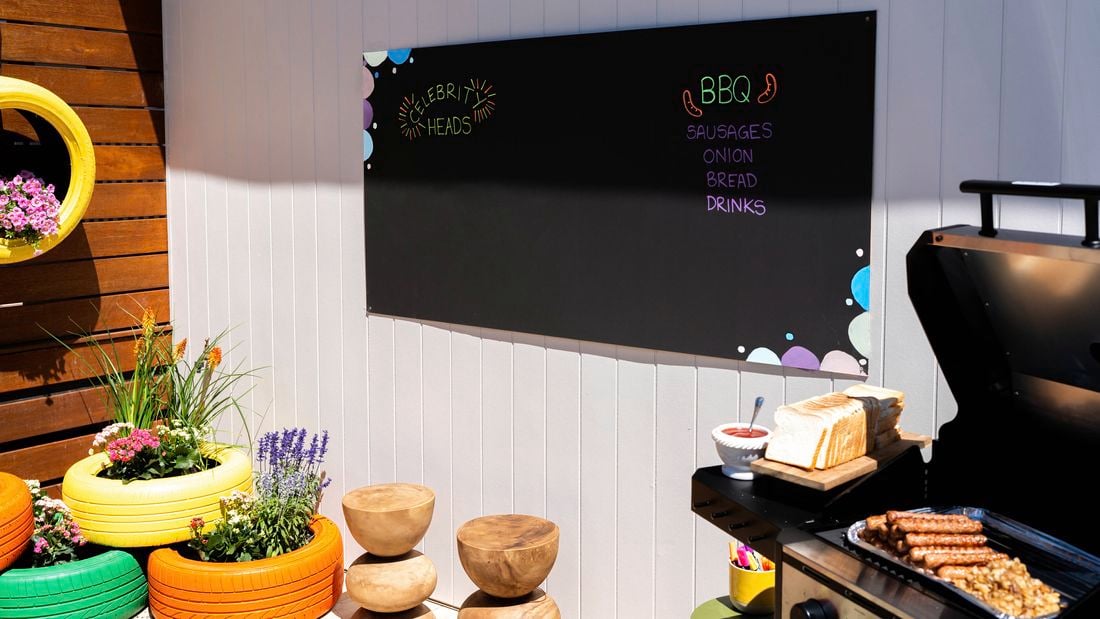 A completed chalkboard wall panel used to display a BBQ menu in an outdoor space.