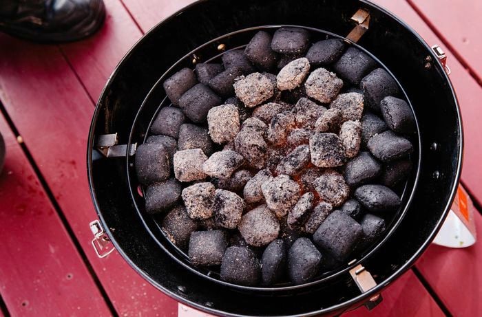 Hot charcoal beads on a smoker rack