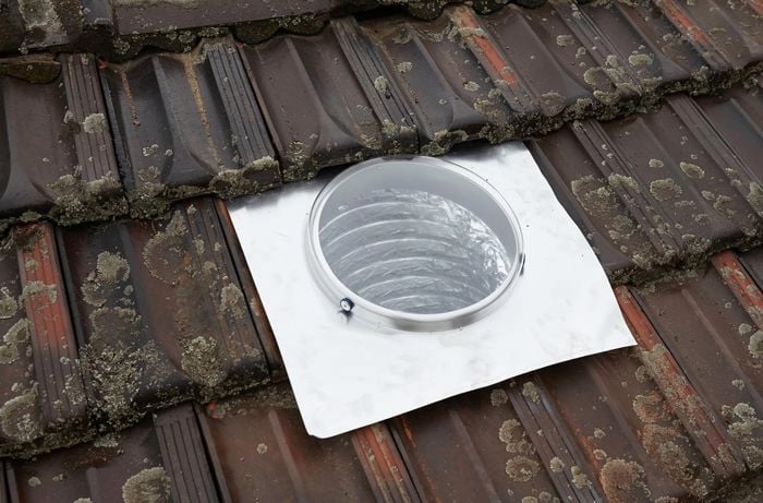 A skylight template and flashing laid out on a roof for positioning purposes