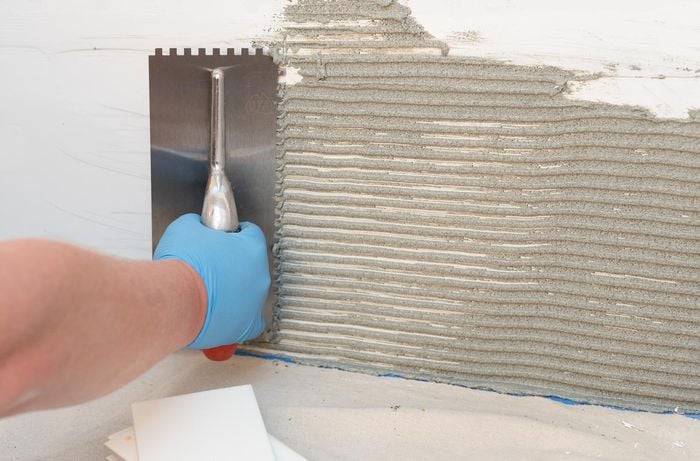 Add adhesive glue to wall