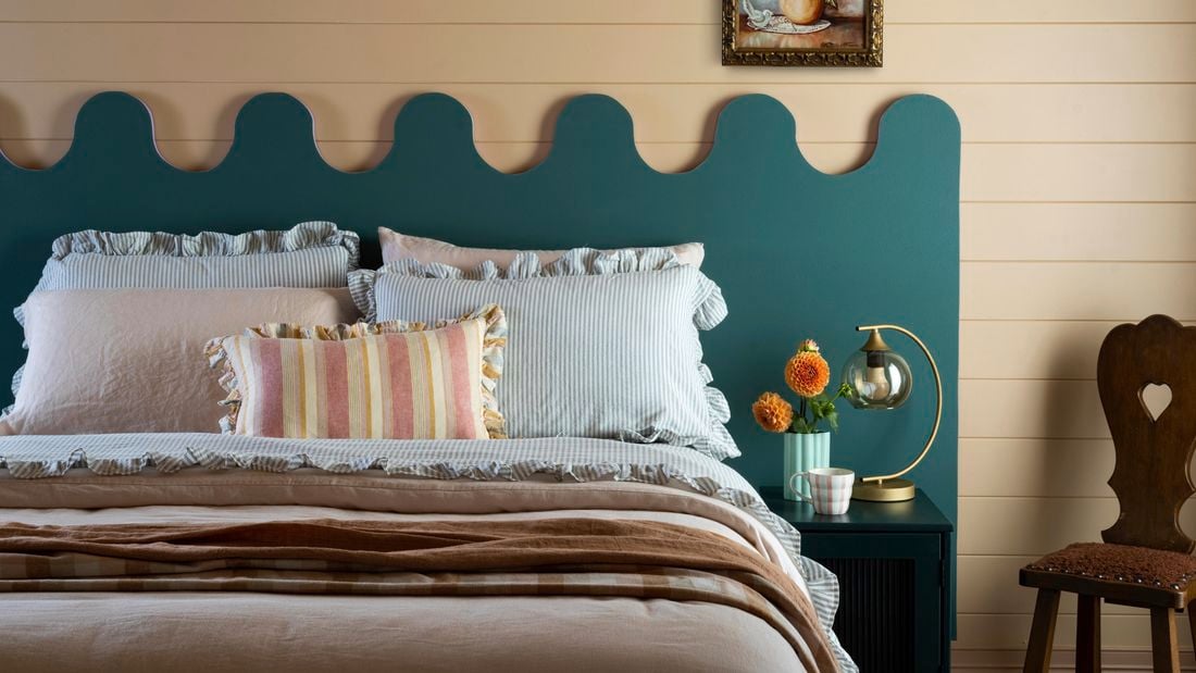 Wavy headboard in blue behind a bed for effect 