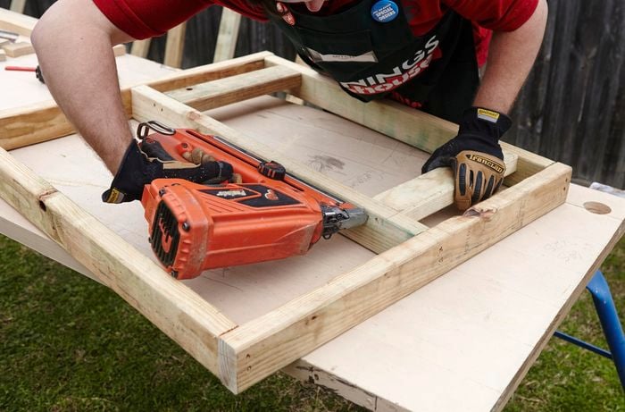A timber frame for a chicken coop being constructed using a nail gun