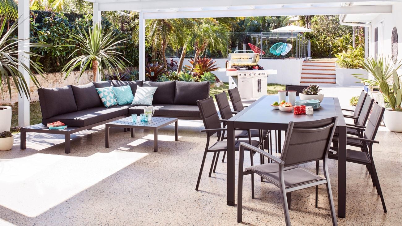 Covered outdoor dining area with dining table and outdoor lounge