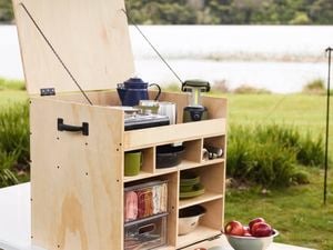 Fully assembled and kitted out camping kitchen box sitting on a tressle table ready to be used