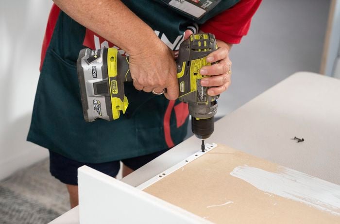 A Bunnings Team Member drilling a screw into a piece of wood
