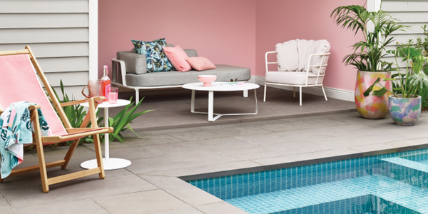 Outdoor pool area with outdoor furniture, and pink colour palette.