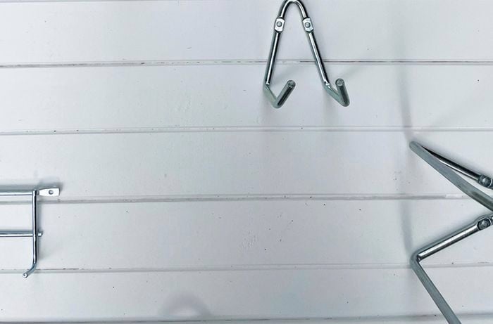 Tool storage hooks on a painted panelled board