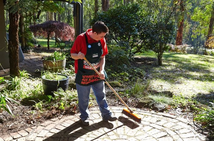Person creating fire break in garden.