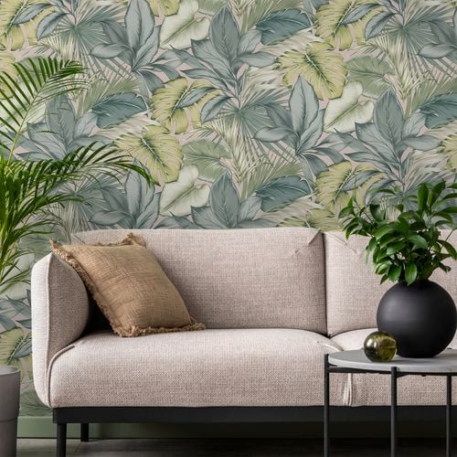 Tropical leaves on wallpaper in living space.