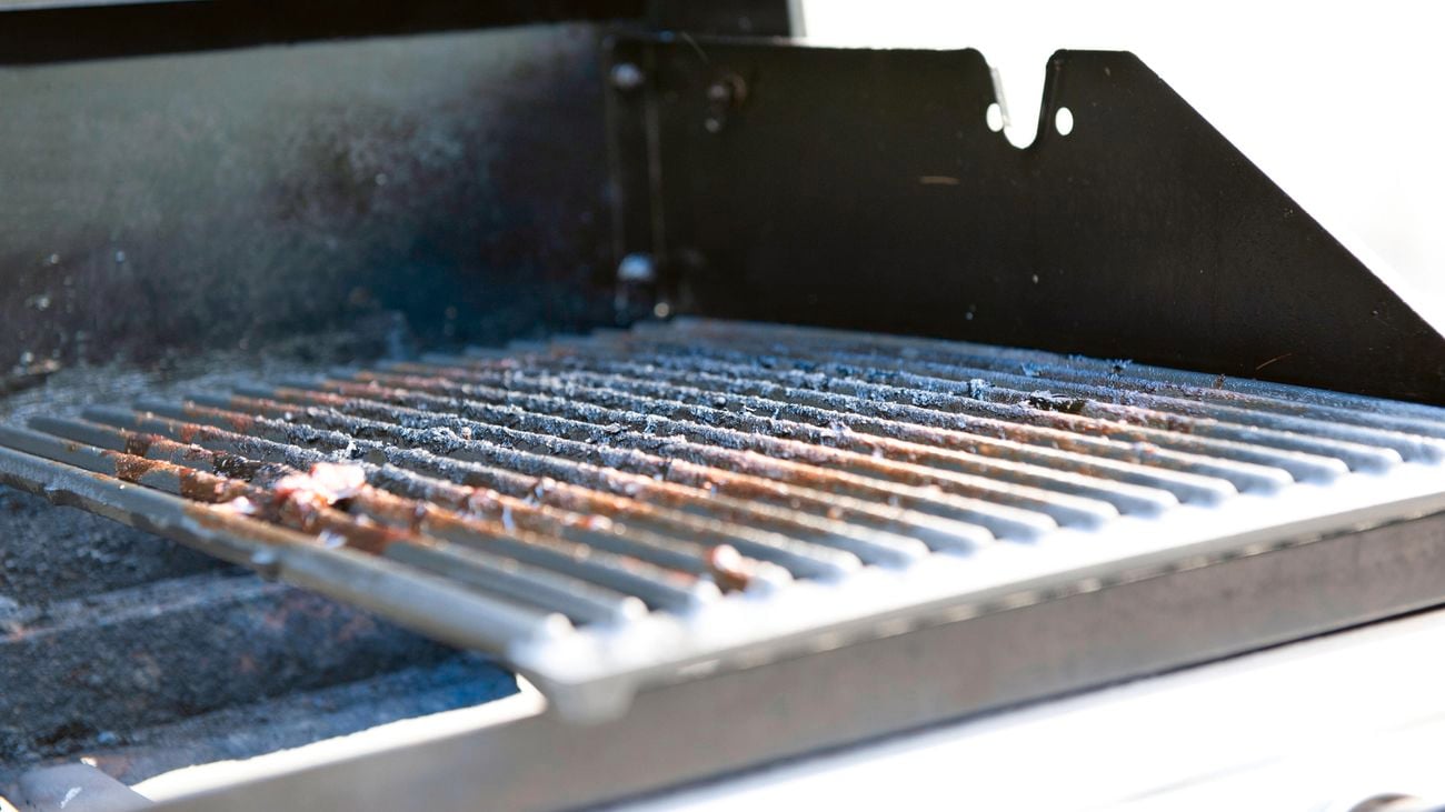 Close up of a dirty barbeque grill.