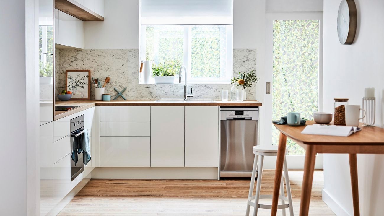 Kitchen with white cupboards and timber benchtops.
