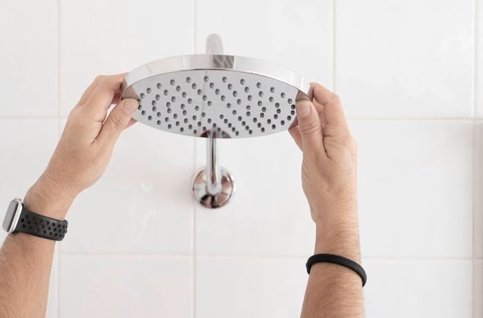Attaching the new shower head to the shower arm.