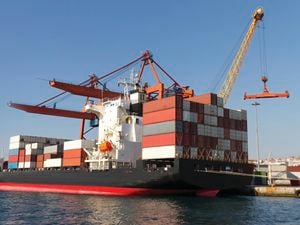 A ship loaded with shipping containers at dock