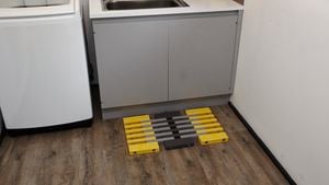 A wooden floor mat in front of a laundry sink