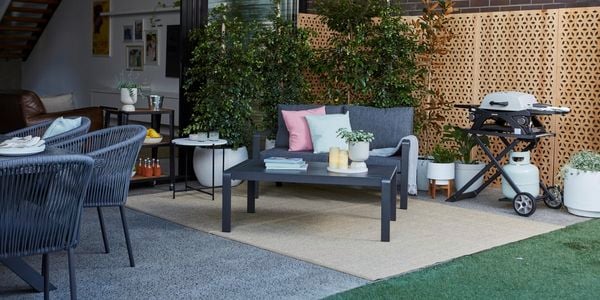 Outdoor setting in courtyard next to BBQ and plants