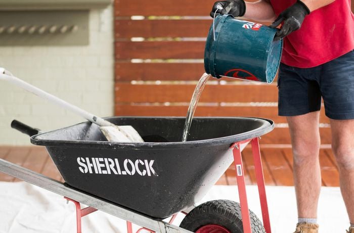 Add water gradually to the dry concrete mix