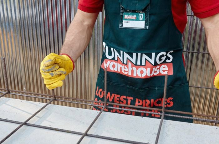 A Bunnings team member lining up two sheets of wire mesh for welding