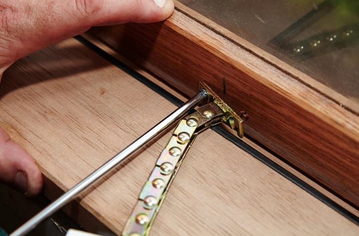 A winder chain being affixed to the inside of a window