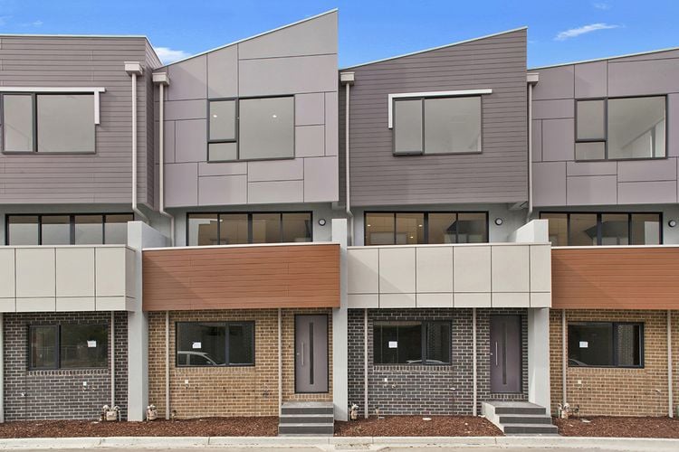 Exterior of a group of townhouses with a variety of wall cladding