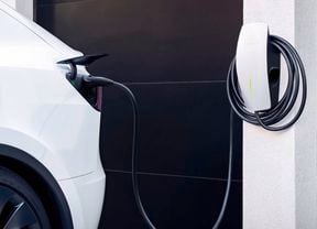 Tesla EV Charger installed on outside wall next to car