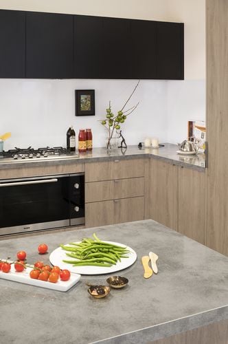 Vegetables on a kitchen bench and an oven and gas cooktop