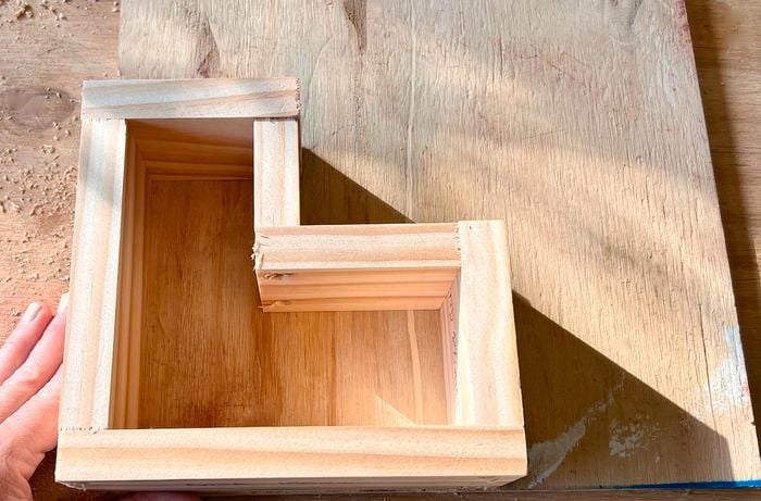 An L-shaped mould made of DAR pine on a timber boar.